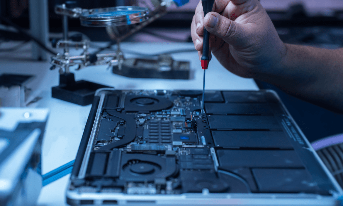 The engineer repairs the laptop and the motherboard. P