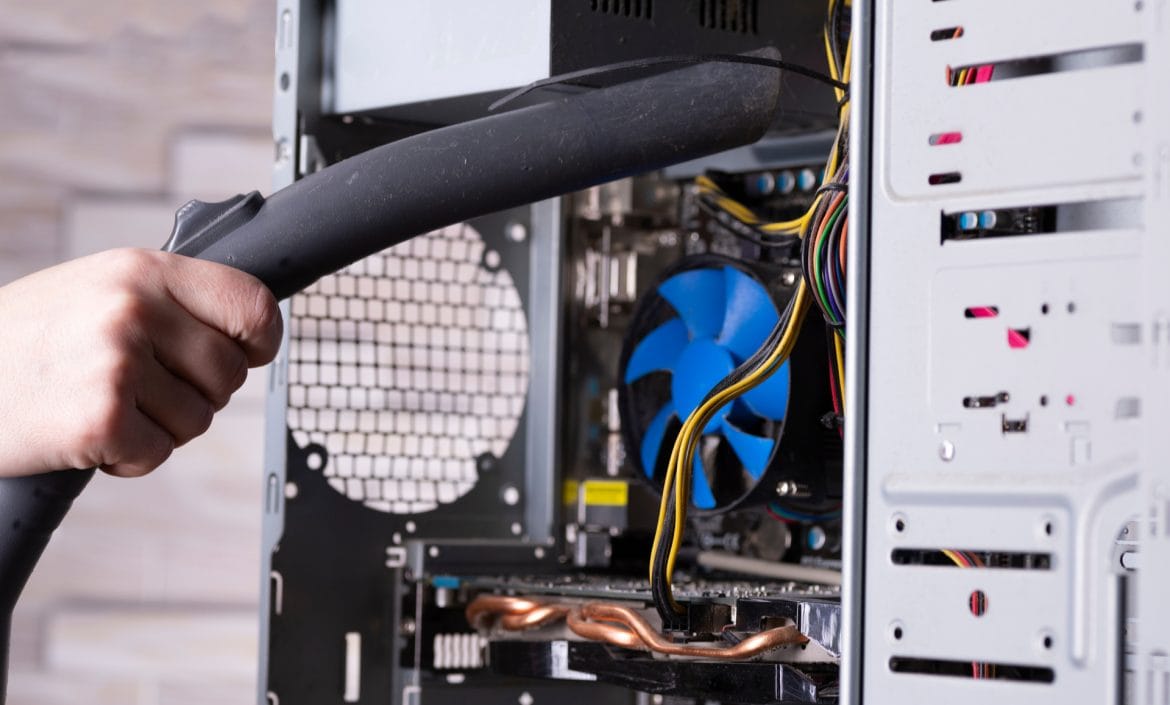 Cleaning the system unit of a desktop computer from dust with a vacuum cleaner