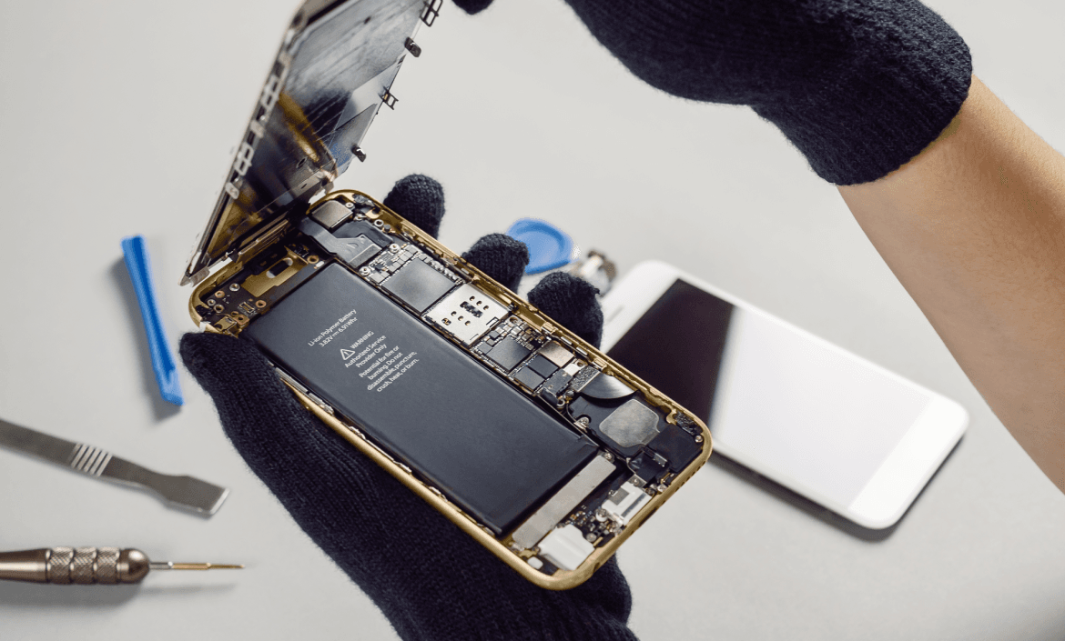 Technician or engineer opening broken smartphone for repair or replace new part on desk