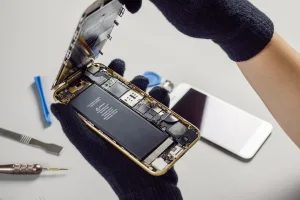 Technician or engineer opening broken smartphone for repair or replace new part on desk