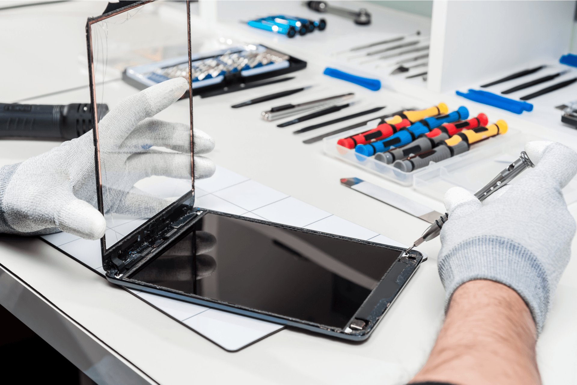 Close-up photos showing process of tablet device repair